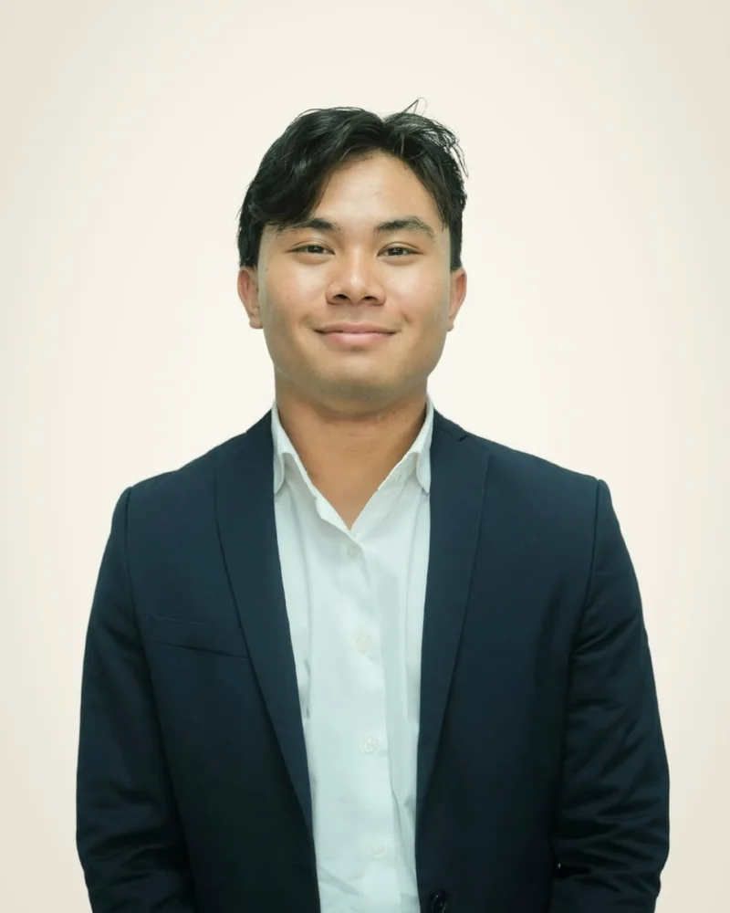 Portrait of Joshua Wang in a navy blazer and white shirt